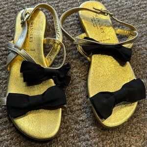 Worn once gold leather sandals with grosgrain black bows. . Twin-Set